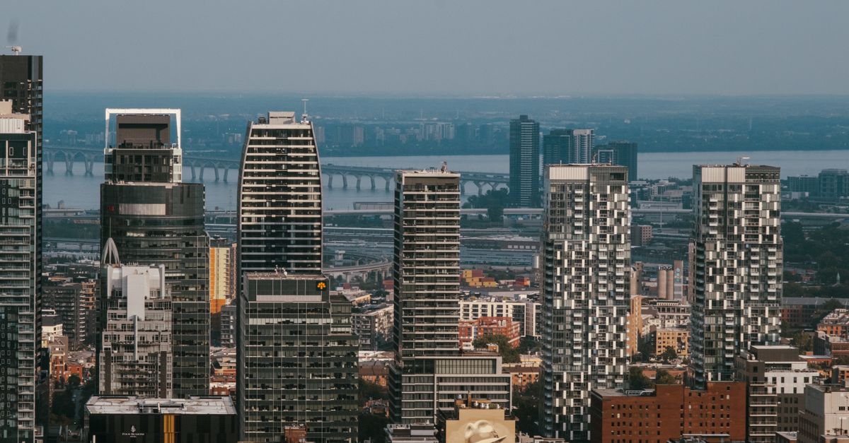 Aerial view of Montreal's skyline featuring the iconic Jacques Cartier Bridge in summer.